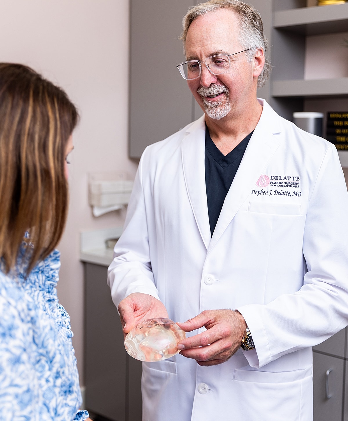Doctor consulting with patient about breast implants.