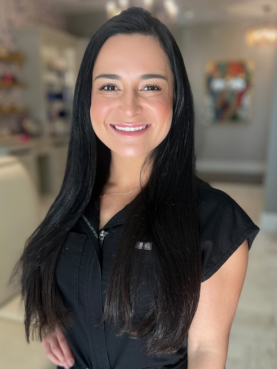 Smiling woman in black attire, indoors.