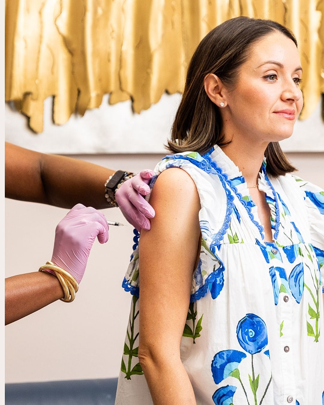 Woman receiving an injection in a medical setting.