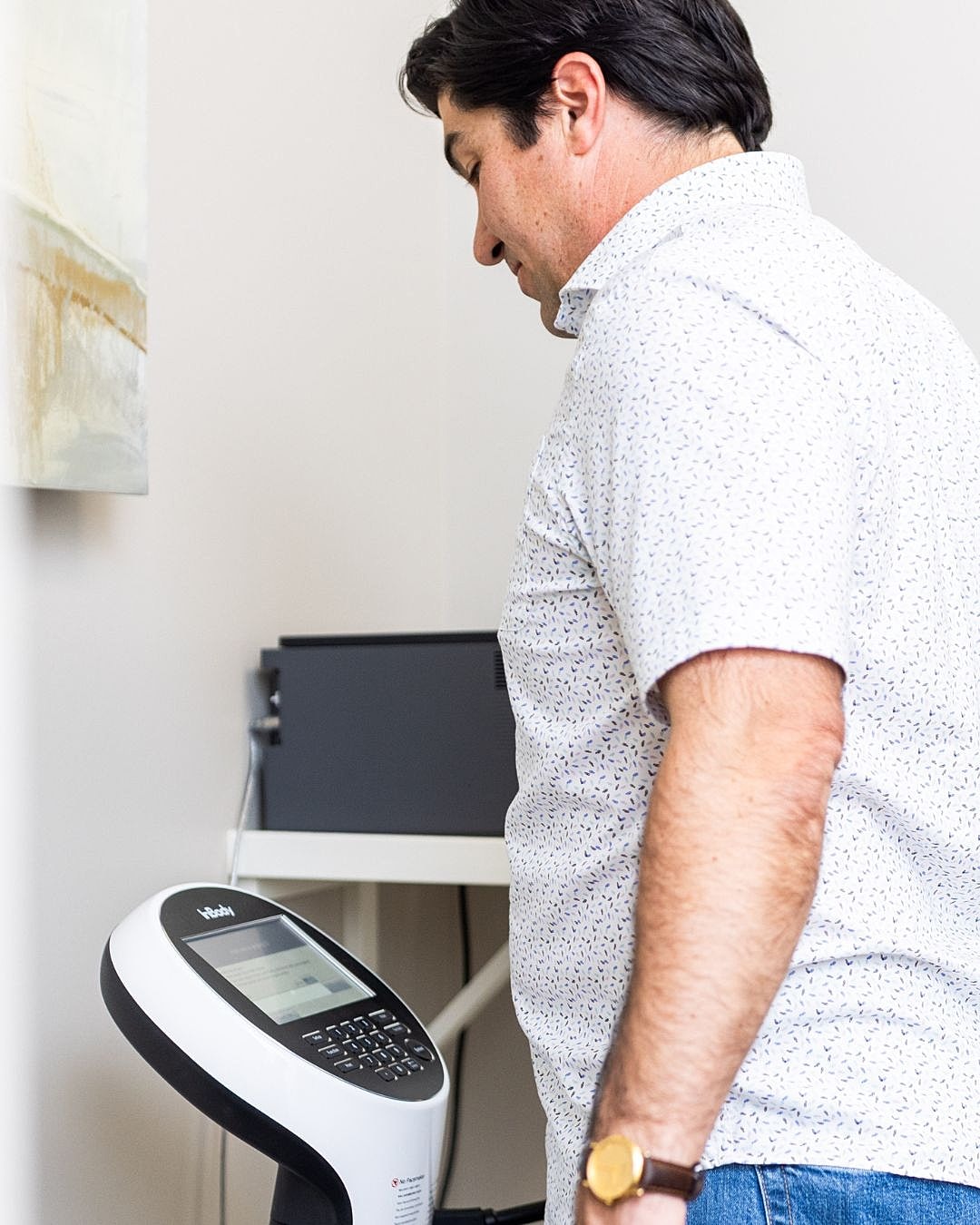 Man using a medical device in an office.