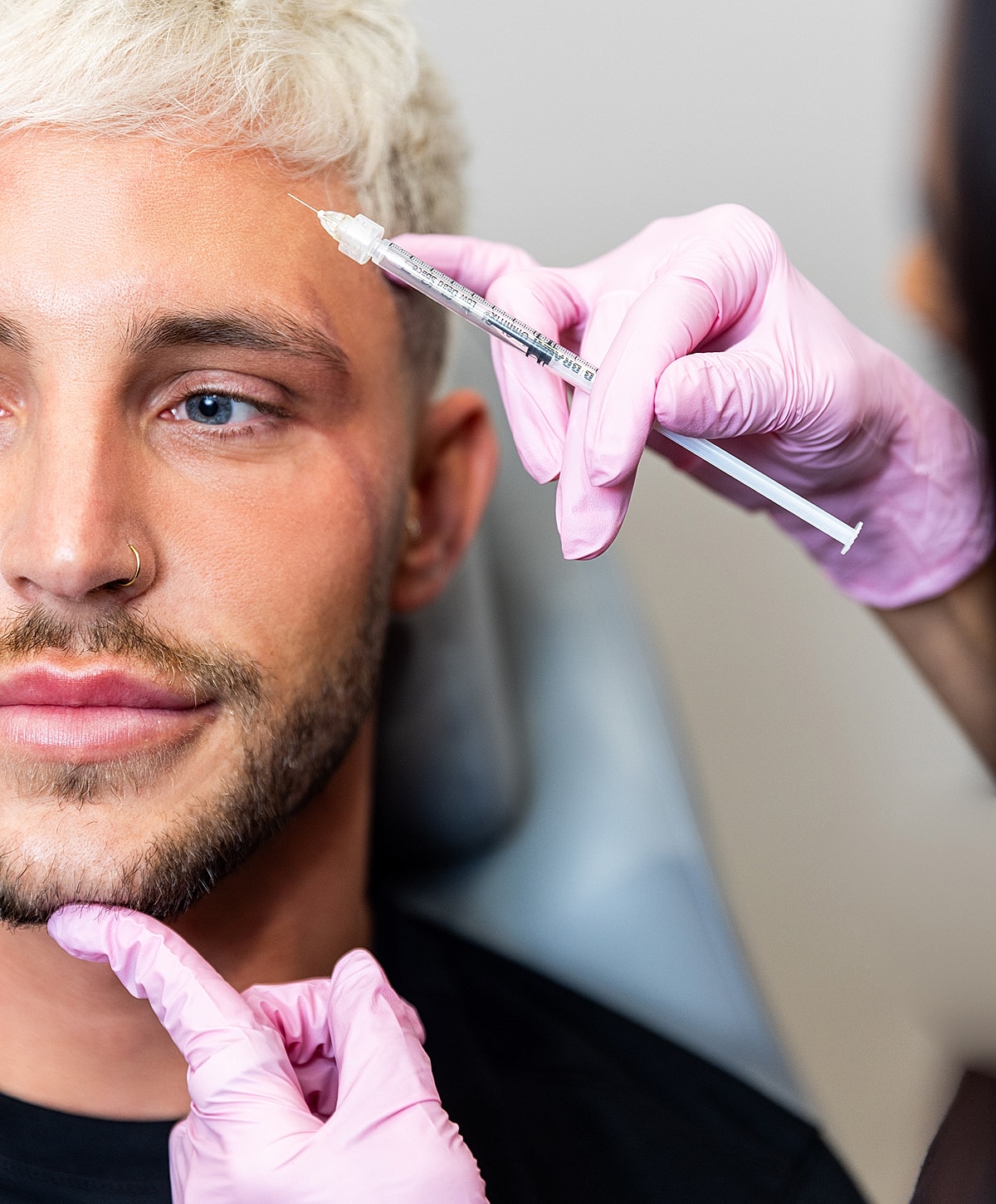 Man receiving cosmetic injection in a clinic.