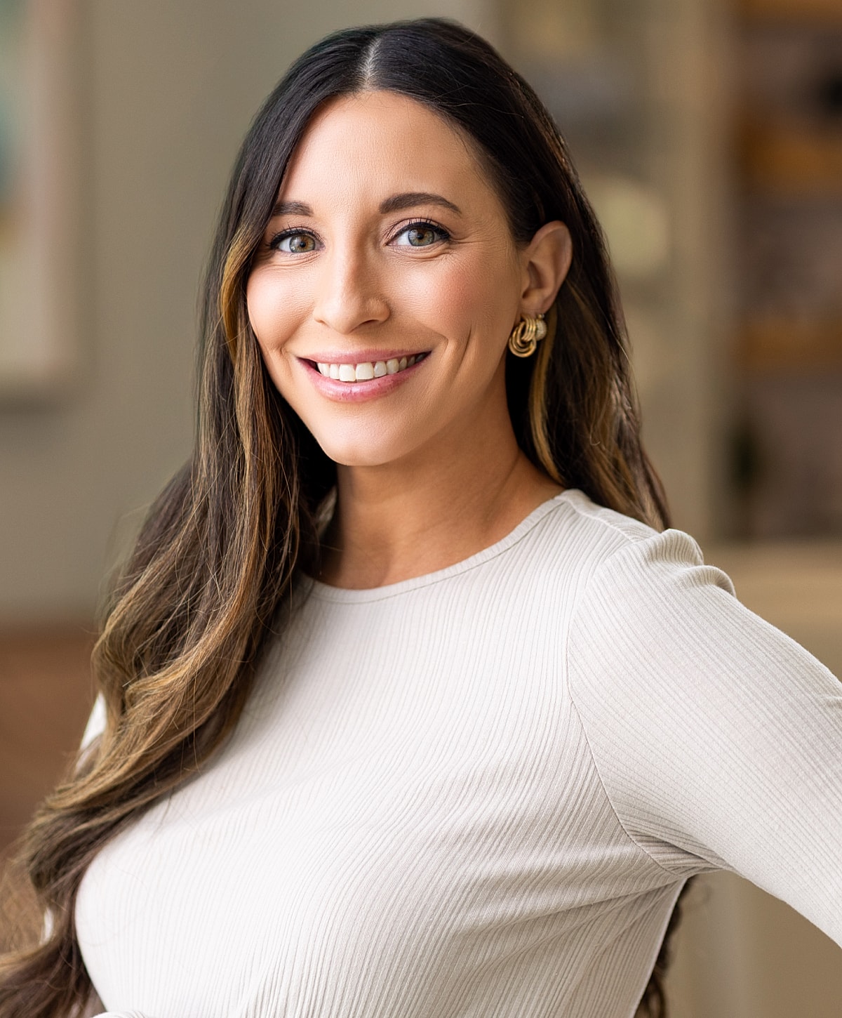 Smiling woman in casual black clothing, indoors.
