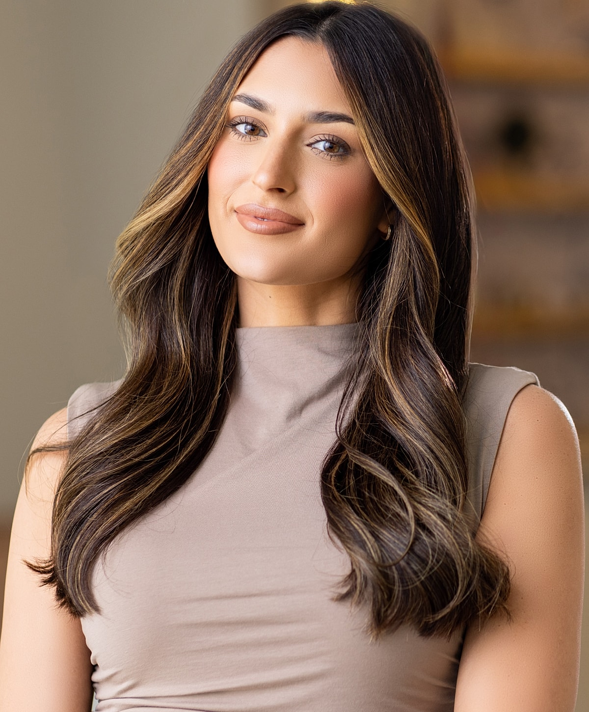 Smiling woman in a black outfit indoors.