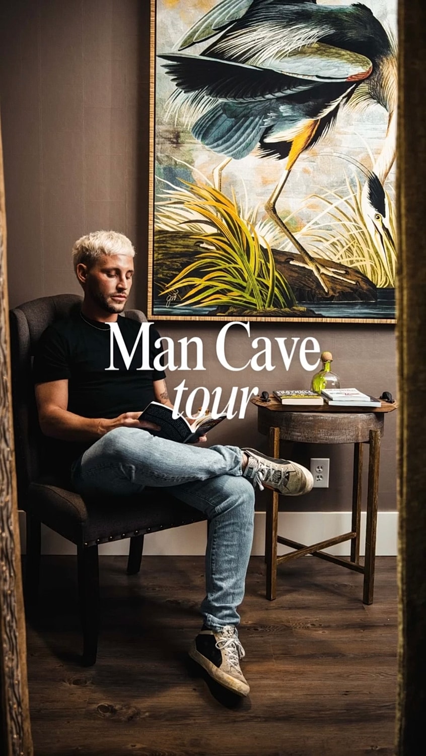 Man relaxing in stylish man cave interior.
