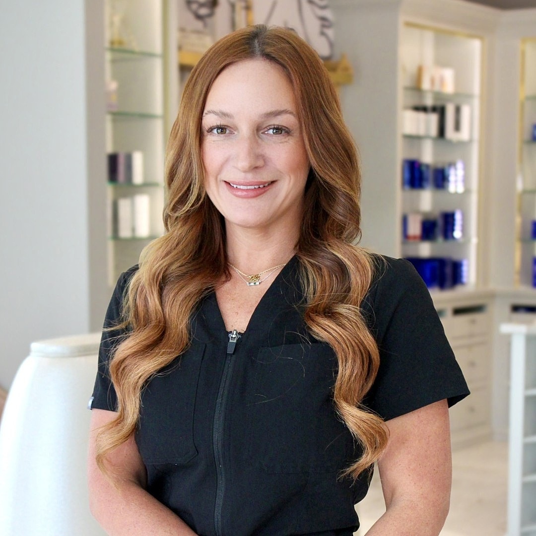 Professional woman smiling in a beauty salon.