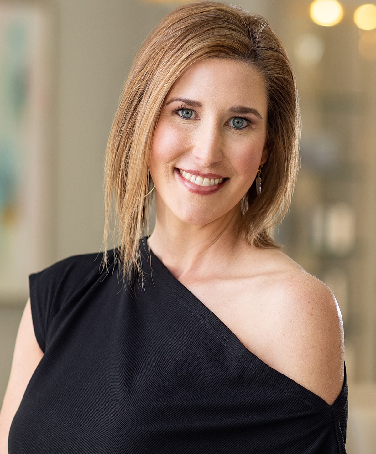 Female professional in black scrubs, smiling confidently.