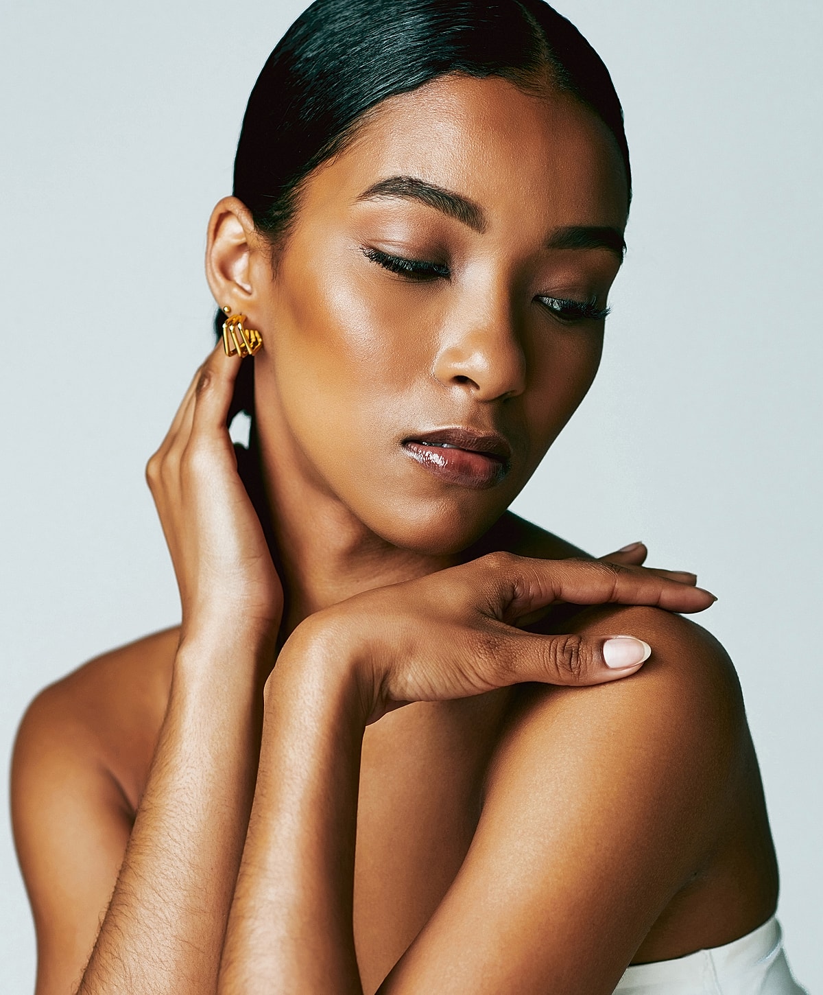Close-up of a woman showcasing elegant earrings.