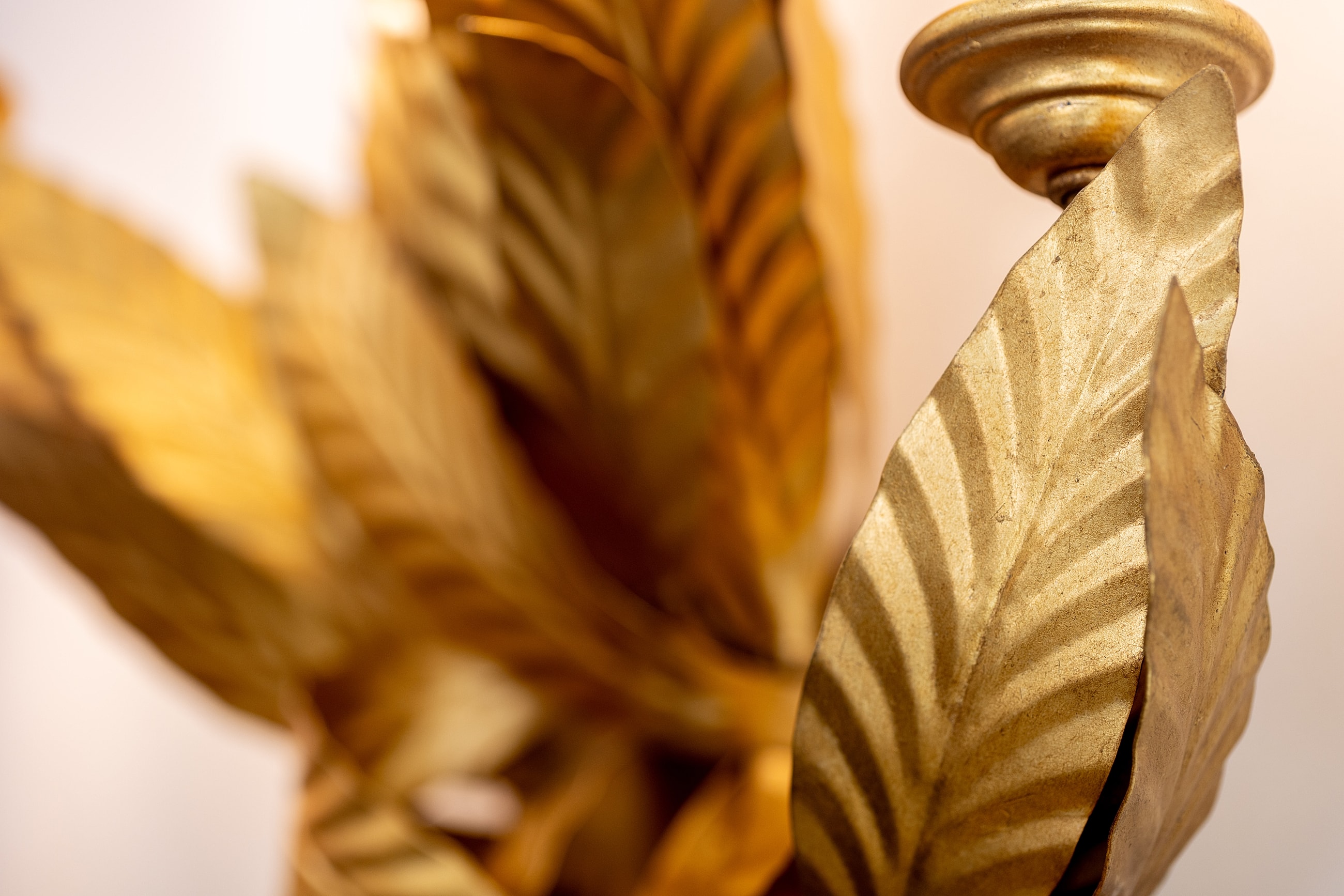 Gold decorative leaves on an ornate fixture.