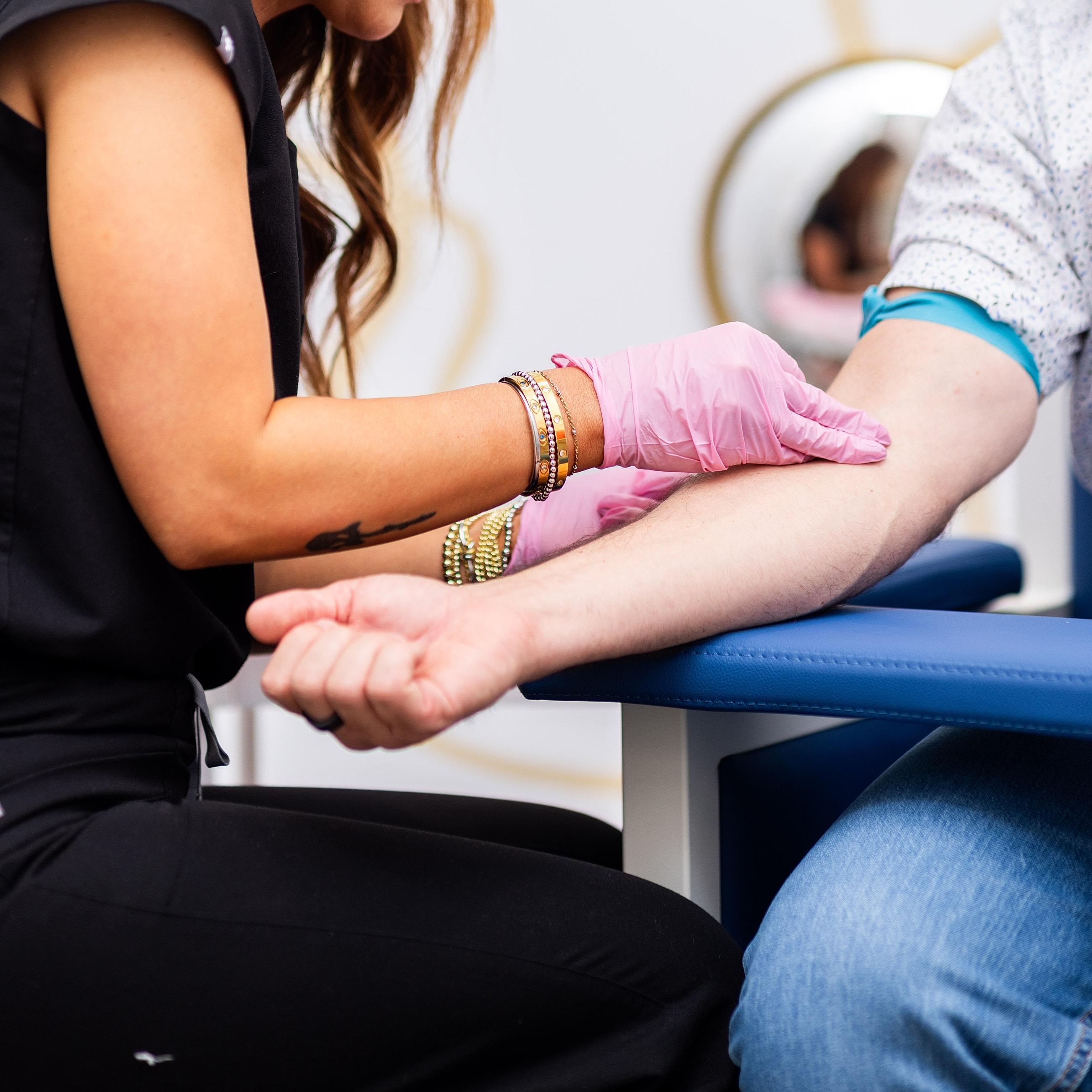 Health professional preparing for an arm procedure.