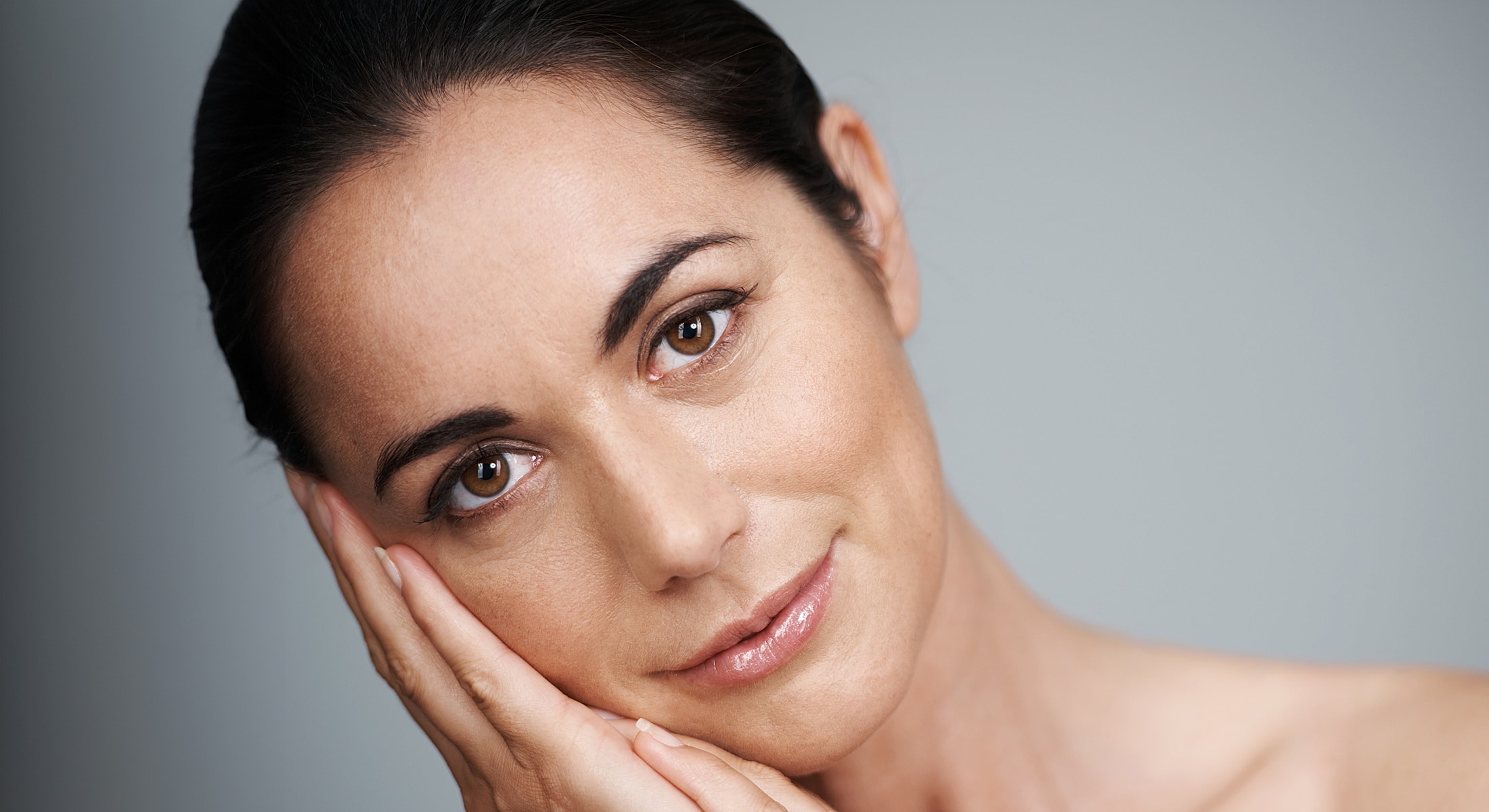 Woman resting her face with a gentle smile.