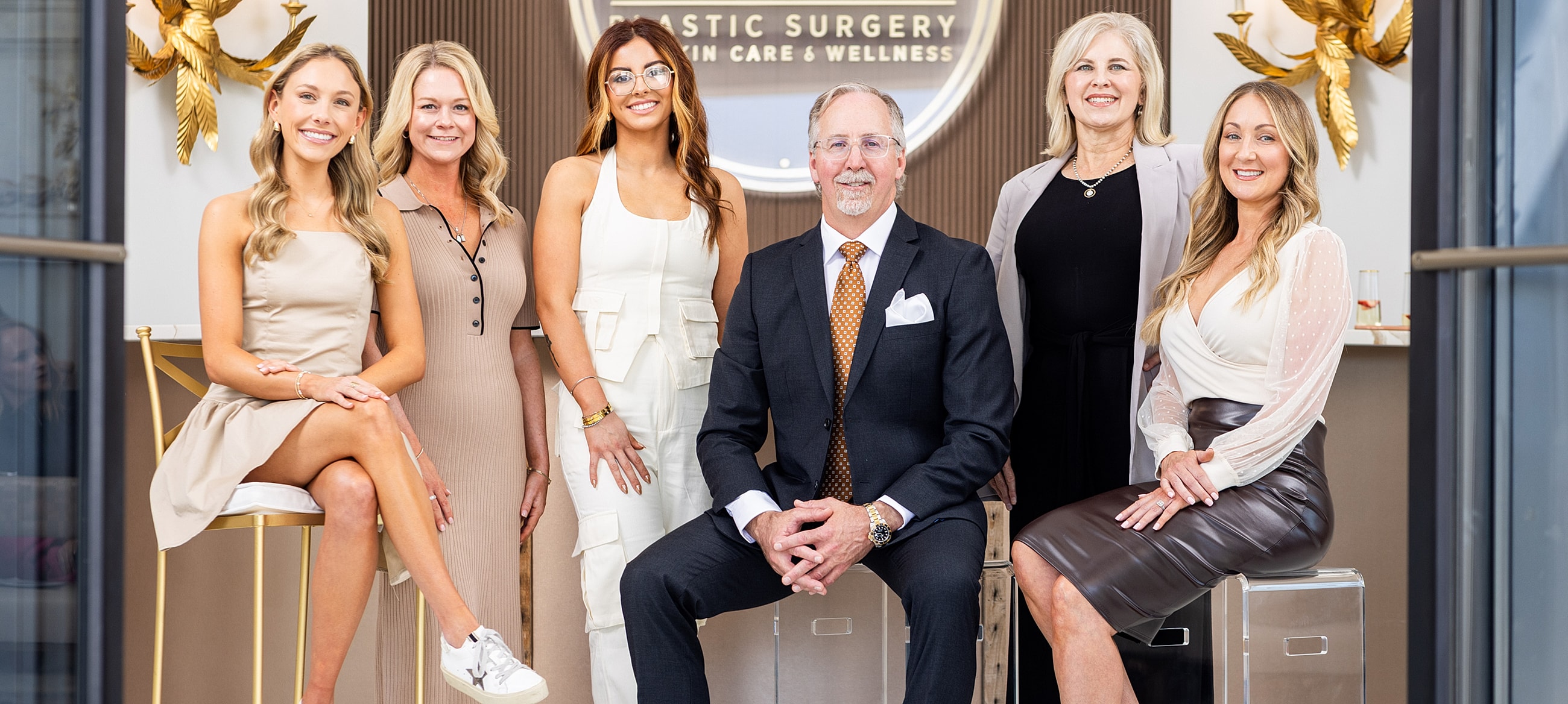 Women posing together on a green couch.